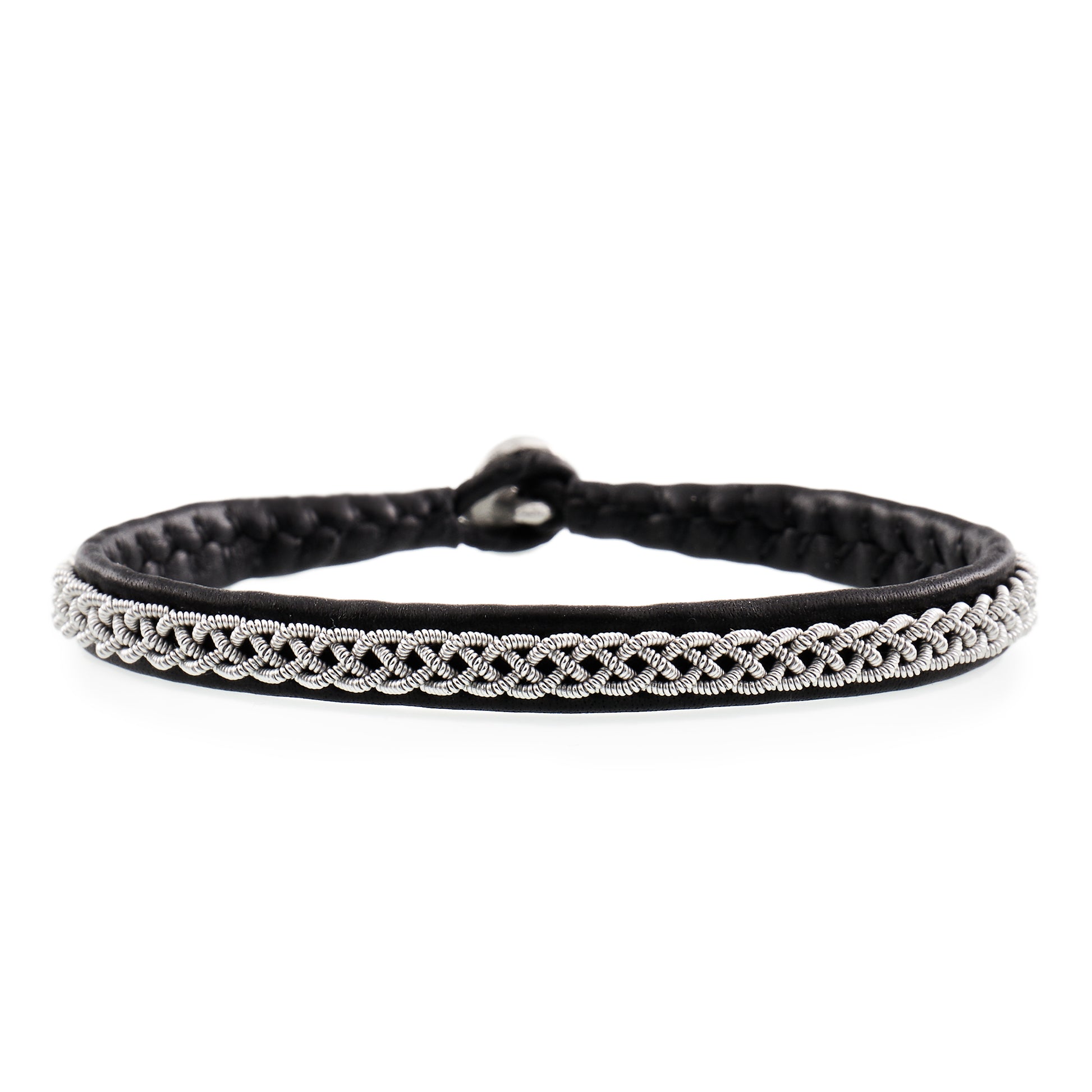 Handmade Sami tin bracelet in braided leather with woven tin wire, Nordic design inspired by traditional craftsmanship from Sápmi
